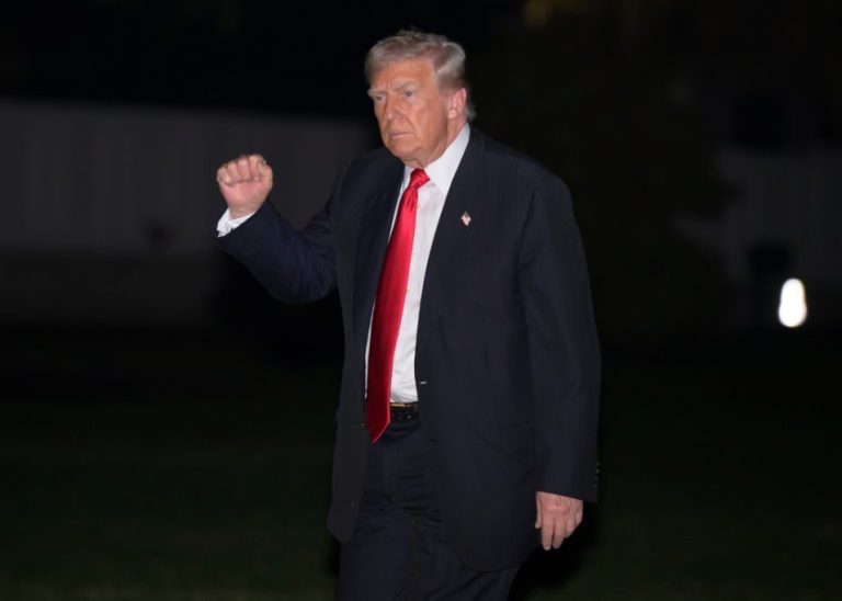 President Donald Trump gestures as he walks across the South Lawn upon arrival at the White House in Washington, Sunday, Nov. 9, 2025.