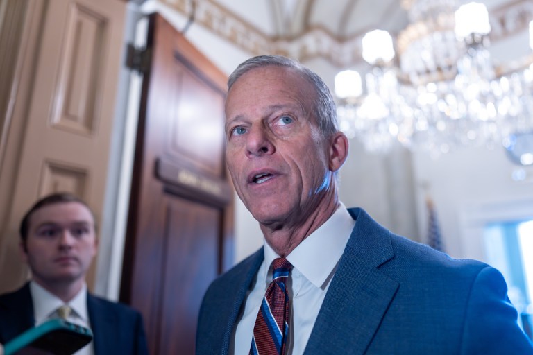 Senate Majority Leader John Thune, R-S.D., speaks to reporters as he arrives at his office following a weekend vote to move forward with a stopgap funding bill to reopen the government through Jan. 30, at the Capitol in Washington