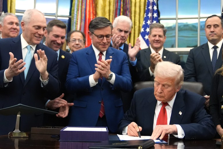 Rep. Steve Scalise (R-LA) and House Speaker Mike Johnson (R-LA) applaud as President Donald Trump signs a funding bill in the Oval Office.