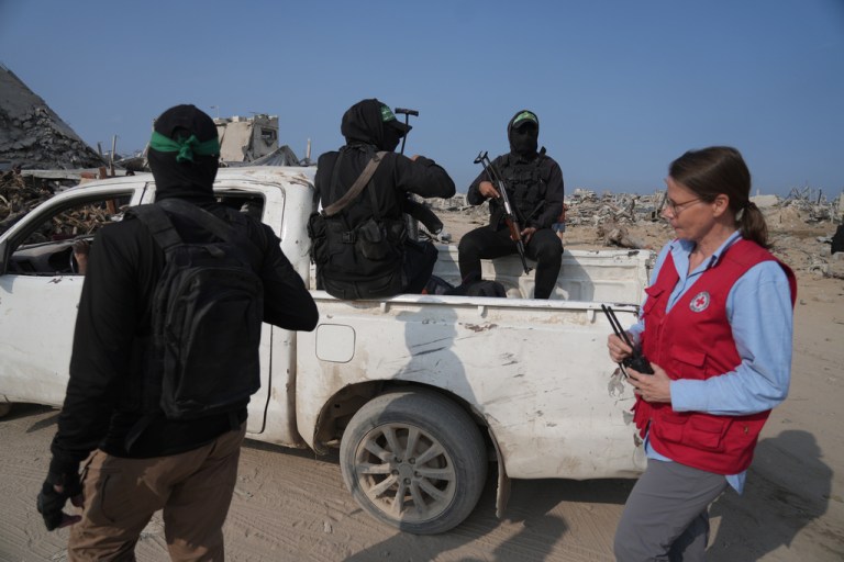 Hamas militants, accompanied by members of the International Committee of the Red Cross.