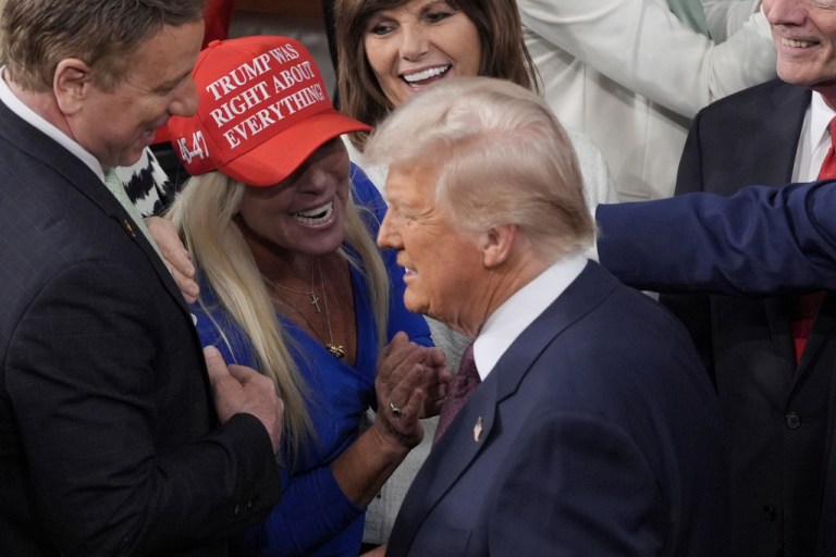President Donald Trump arrives and walks by Rep. Marjorie Taylor Greene, R-Ga., to address a joint session of Congress.