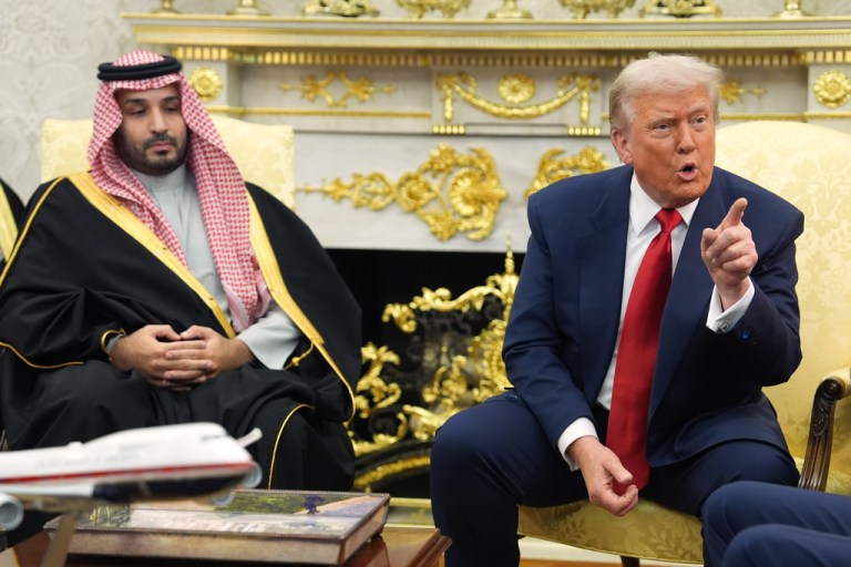 President Donald Trump points to a reporter as he meets with Saudi Arabian Crown Prince Mohammed bin Salman in the Oval Office.