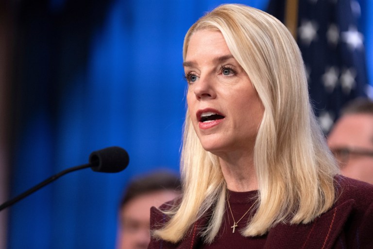 Attorney General Pam Bondi speaks into a microphone.
