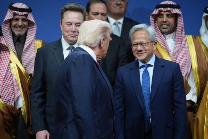President Donald Trump speaks with Elon Musk and Nvidia CEO Jensen Huang, during the Saudi Investment Forum at the Kennedy Center, Wednesday, Nov. 19, 2025, in Washington.