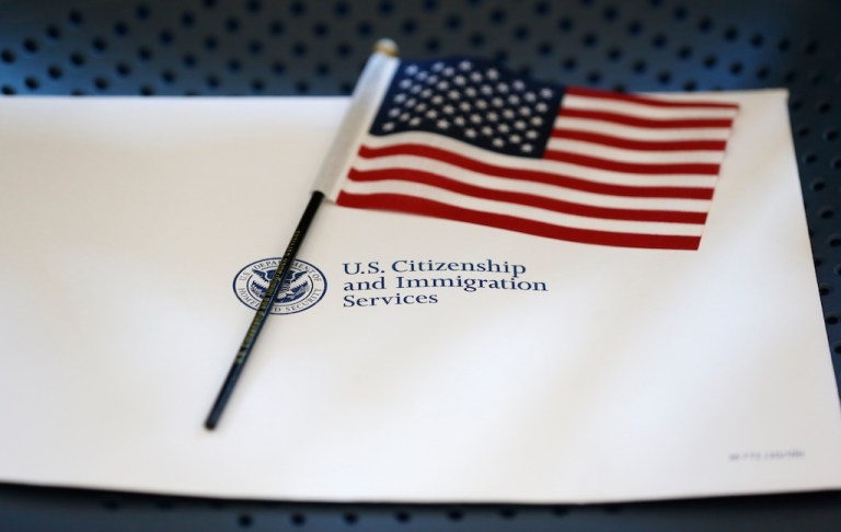 FILE - An information packet and an American flag are placed on a chair at the U.S. Citizenship and Immigration Services Miami Field Office on Aug. 17, 2018, in Miami. (AP Photo/Wilfredo Lee, File)