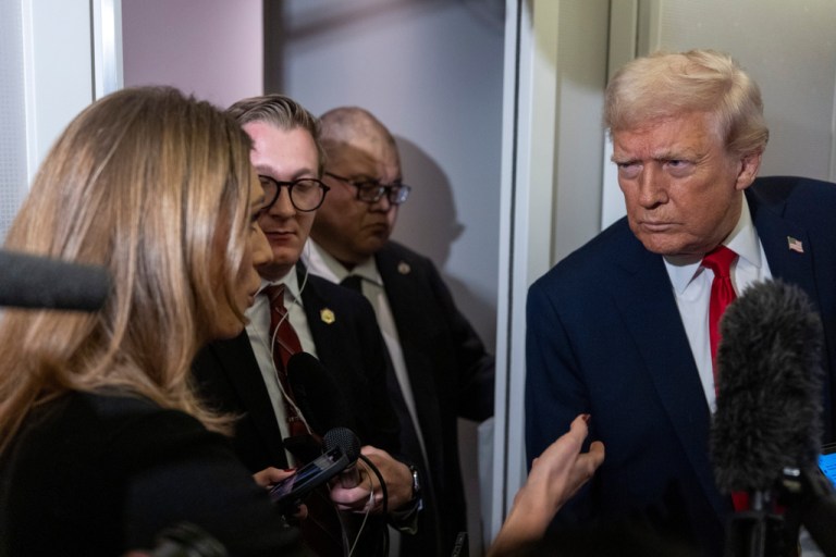 President Donald Trump leans in to hear a question as he speaks with reporters while in flight on Air Force One from Joint Base Andrews to his Mar-a-Lago estate in Palm Beach, Fla., Tuesday, Nov. 25, 2025. (AP Photo/Alex Brandon)