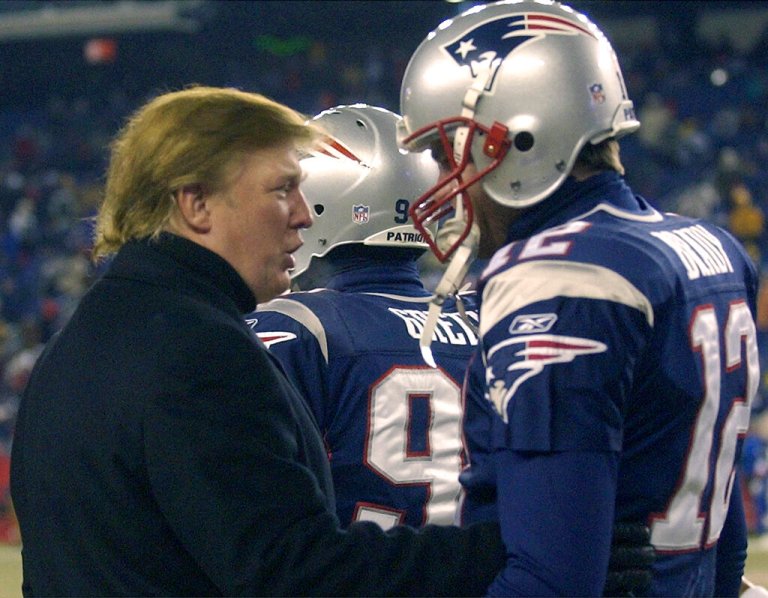 Donald Trump, left, stops to talk to New England Patriots quarterback Tom Brady prior to the start of the game at Gillette Stadium, Saturday, Jan. 10, 2004, in Foxborough, Mass., where the Patriots will play the Tennessee Titans in a AFC divisional playoff game. (AP Photo/Elise Amendola)