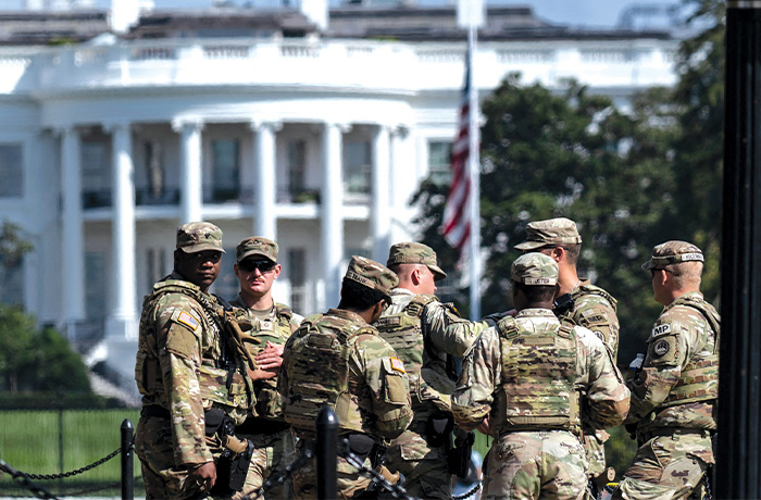 National Guard troops stand in Lafayette Park, with the White House in the background, in Washington. (Photo by Andrew Caballero-Reynolds/AFP via Getty Images)