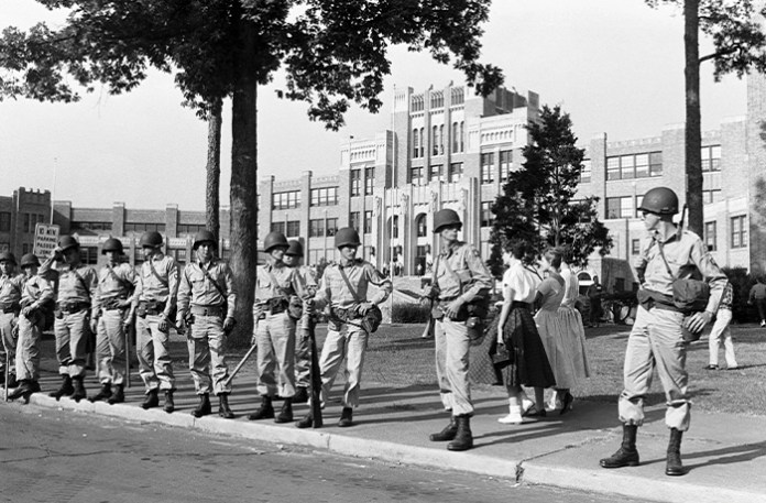 Riots and protests broke out when black students started attending Little Rock Central High School in 1957. Former President Dwight D. Eisenhower placed the Arkansas National Guard under federal control and deployed troops to the school to protect the students and ensure the reluctant state and city governments of Arkansas upheld the law. (Corbis via Getty Images)