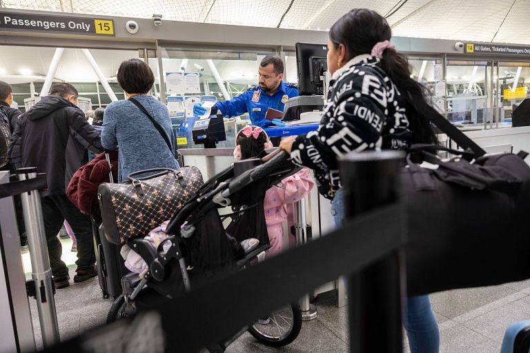 Ecuadorian immigrant Andrea, 28, prepares to pass through a TSA checkpoint before departing with her children for Ecuador at JFK International Airport on October 26, 2025 in New York, New York. Andrea, along with her cousin Jennyfer, 22, decided to 