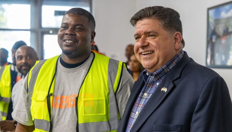 Kellen McMiller, a member of the Chicago Peacekeepers, posing for a picture with Gov. JB Pritzker (D-IL) | Source: Pritzker's press office (Archived)