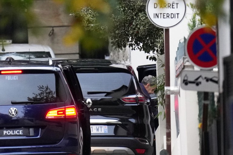 Nicolas Sarkozy leaves a car after arriving at home