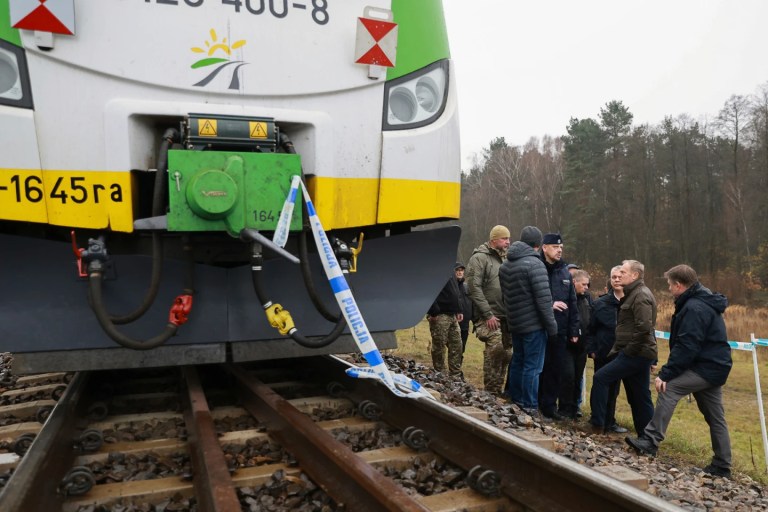 Prime Minister Donald Tusk, second right, visits site of the rail line Mika, that was damaged by sabotage, near Deblin, Poland, Monday, November 17, 2025. (AP Photo/KPRM)