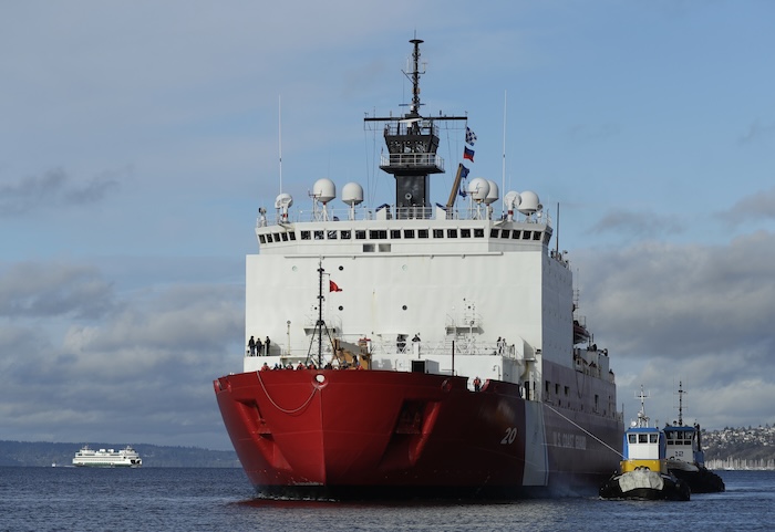Tugboats help the U.S. Coast Guard Cutter Healy icebreaker into her homeport.