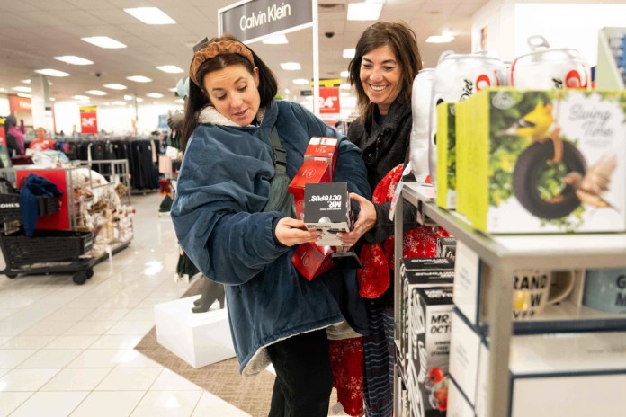 Becca Mendoza and Tammi Hines look at products as shoppers browse through Kohl's department store for Black Friday deals, Friday, Nov. 28, 2025, in Woodstock, Ga. (AP Photo/Megan Varner)