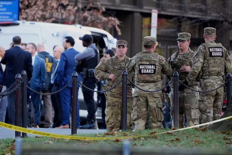 Emergency personnel gather in a cordoned off area where National Guard soldiers were shot near the White House.