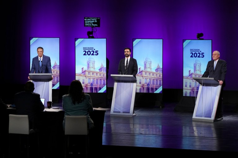 Andrew Cuomo, Curtis Sliwa and Zohran Mamdani stand on the debate stage.