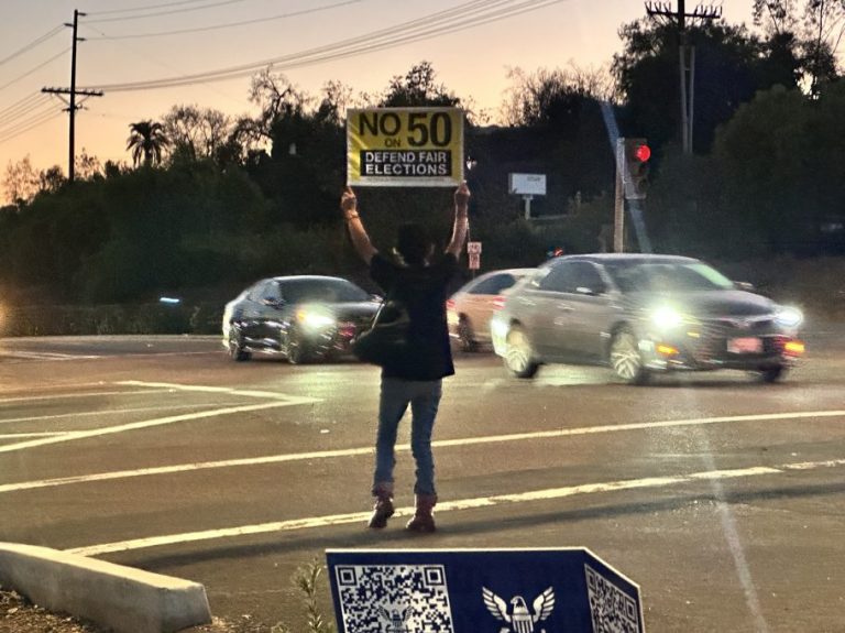 Maria Garcia holds a “No to Prop 50”