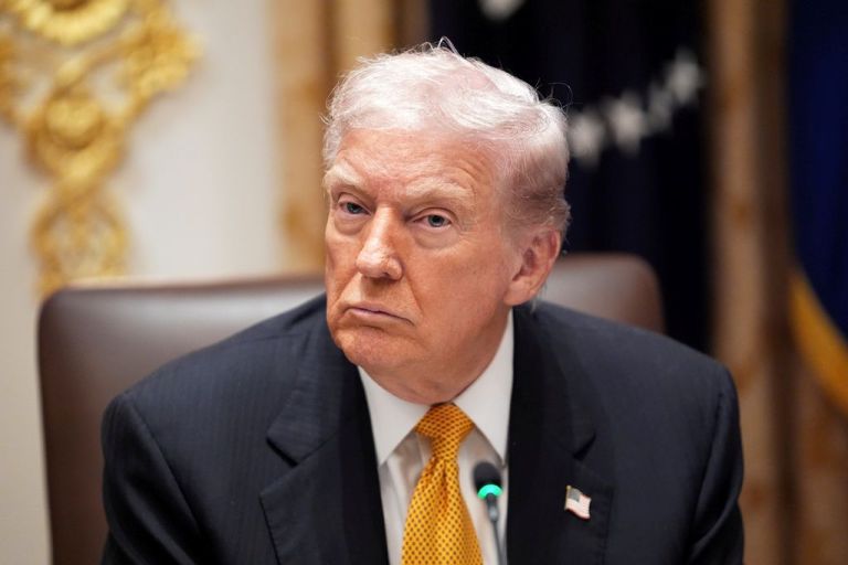 Trump looks on at a press conference.