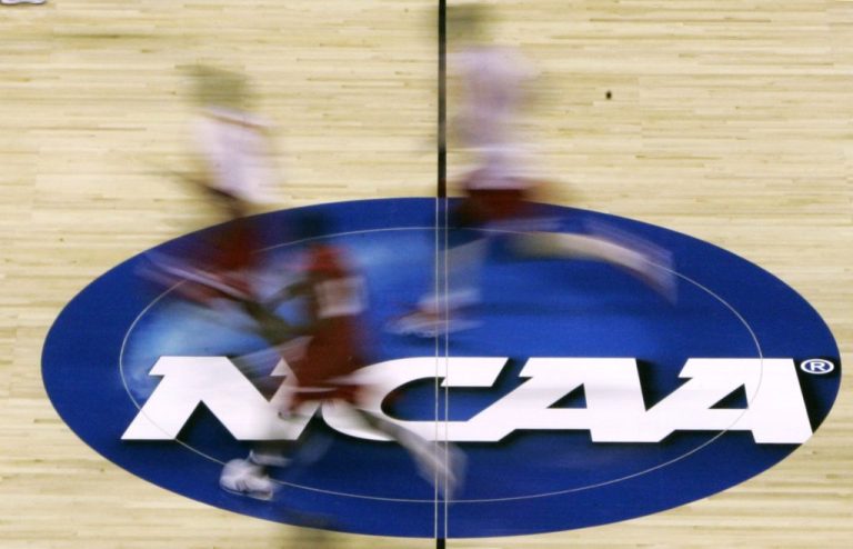 players run across the court during basketball