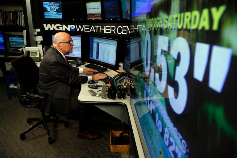 WGN-TV Midday News meteorologist Tom Skilling prepares in his work space at the WGN television studios in Chicago, July 1, 2013. Skilling, long time WGN-TV meteorologist and a well-known local personality, will retire next year after 45 years at the station. (Jose M. Osorio/Chicago Tribune via AP)