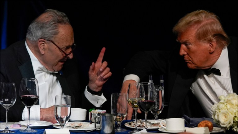 Then-Republican presidential nominee former President Donald Trump talks with then-Senate Majority Leader Chuck Schumer (D-NY).