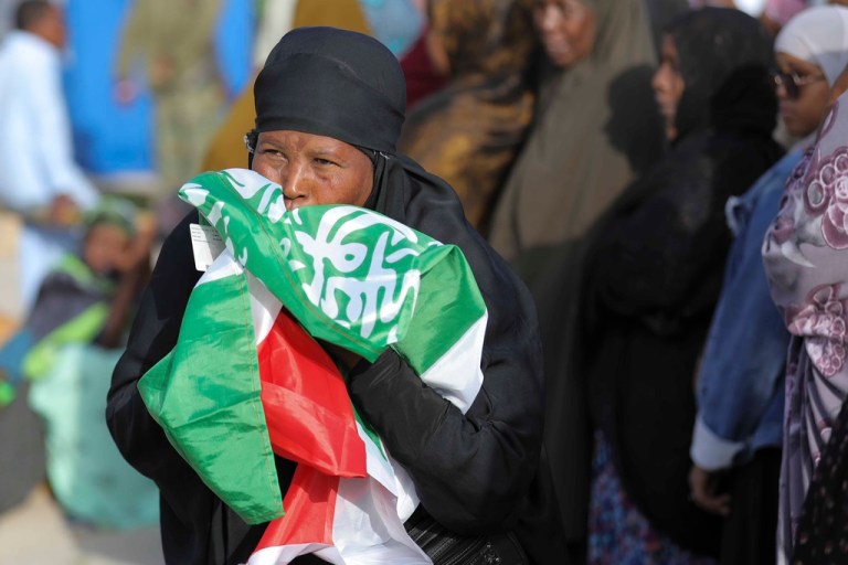 A woman kisses the Somaliland flag.