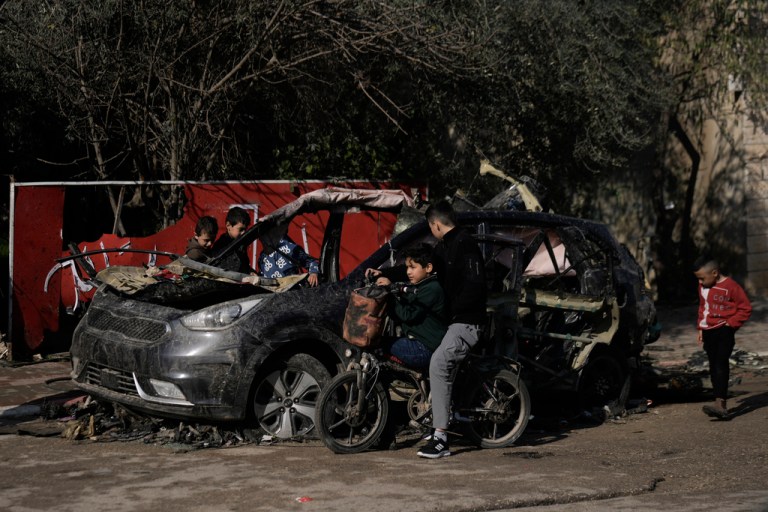 Palestinian children look at the wreckage of a vehicle destroyed in an Israeli strike that killed two Islamic jihadist militants in the West Bank village of Kabatiya.
