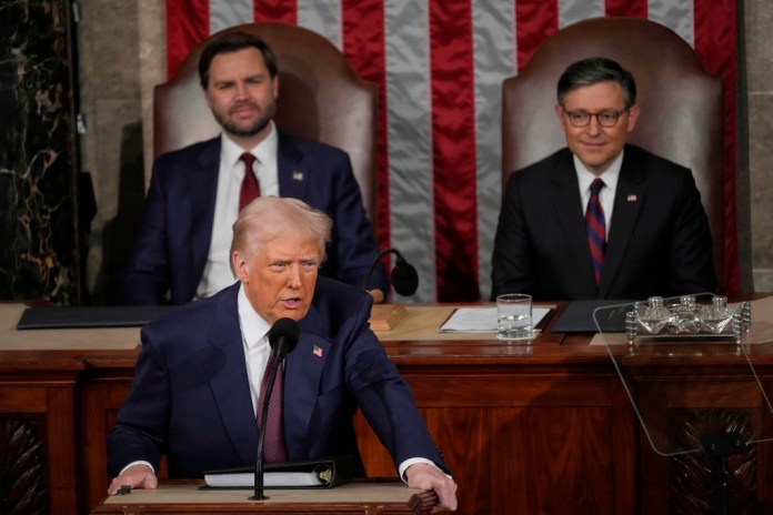 President Donald Trump talks about Greenland as he addresses a joint session of Congress in the House chamber at the Capitol, as Vice President JD Vance and House Speaker Mike Johnson (R-LA) listen.