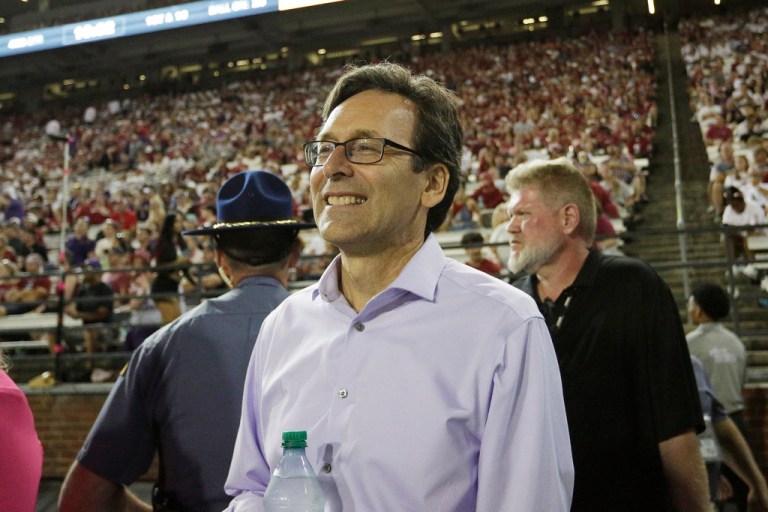 Washington Gov. Bob Ferguson, center, watches the second half of an NCAA college football game between Washington State and Washington, Saturday, Sept. 20, 2025, in Pullman, Wash.