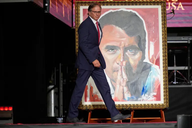 Frank Turek walks on stage to speak at a memorial for conservative activist Charlie Kirk, Sunday, Sept. 21, 2025, at State Farm Stadium in Glendale, Ariz.