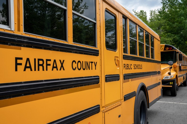 School buses line up outside a Fairfax County middle school in Falls Church, Va., in July 2020.