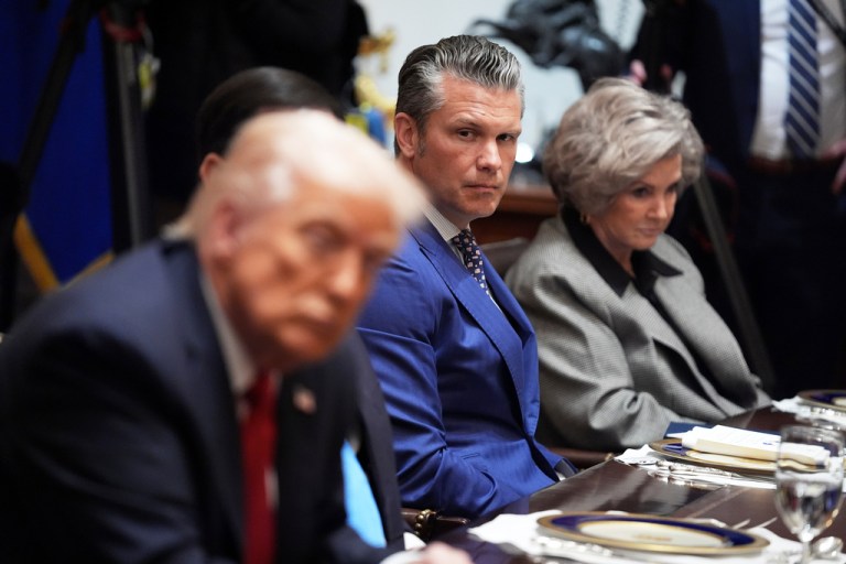 War Secretary Pete Hegseth and White House chief of staff Susie Wiles listen during a meeting with President Donald Trump.