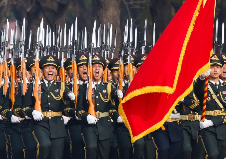 People's Liberation Army honor guard marches past the Great Hall of the People