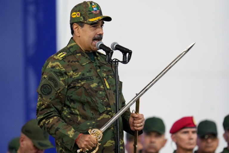 Venezuelan President Nicolas Maduro holds a ceremonial sword said to have belonged to independence hero Simon Bolivar during a government-organized civic-military march in Caracas, Venezuela, Tuesday, Nov. 25, 2025.