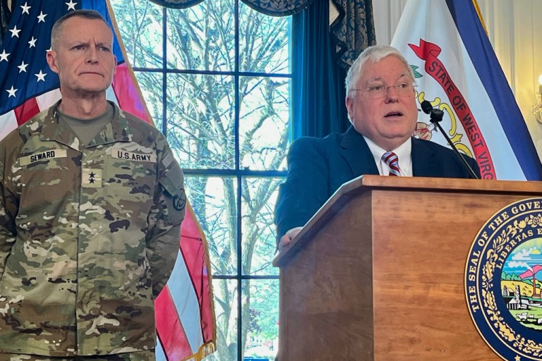 West Virginia Gov. Patrick Morrisey, right, speaks while West Virginia National Guard Maj. Gen. James Seward looks on during a news conference Monday, Dec. 1, 2025, at the West Virginia Capitol in Charleston, W.Va. (AP Photo/John Raby)