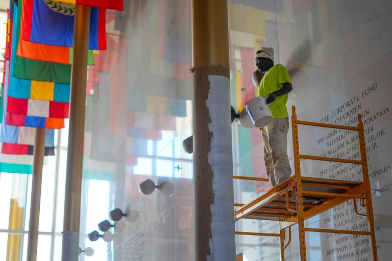 Odden Shaw paints over a gold colored column inside the Hall of Nations at the Kennedy Center for Performing Arts in Washington, Oct. 24, 2025, in preparation for upcoming FIFA World Cup 2026 Final Draw.