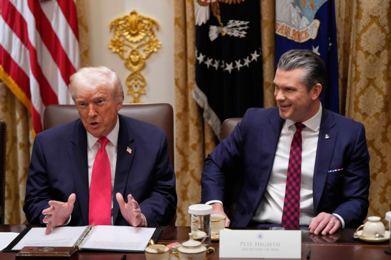 President Donald Trump speaks during a Cabinet meeting at the White House, Tuesday, Dec. 2, 2025, in Washington, as Defense Secretary Pete Hegseth, looks on.