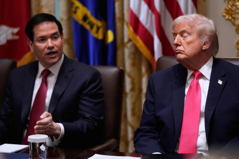 Secretary of State Marco Rubio speaks next to President Donald Trump.