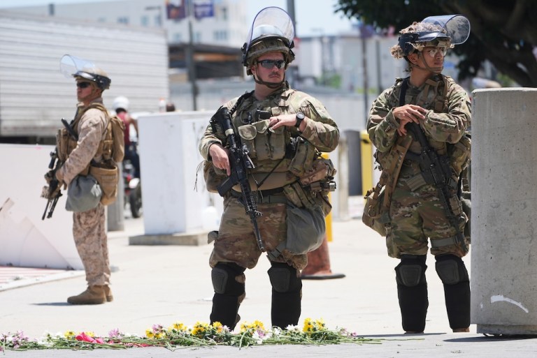California National Guard troops and U.S. Marines guard a federal building.