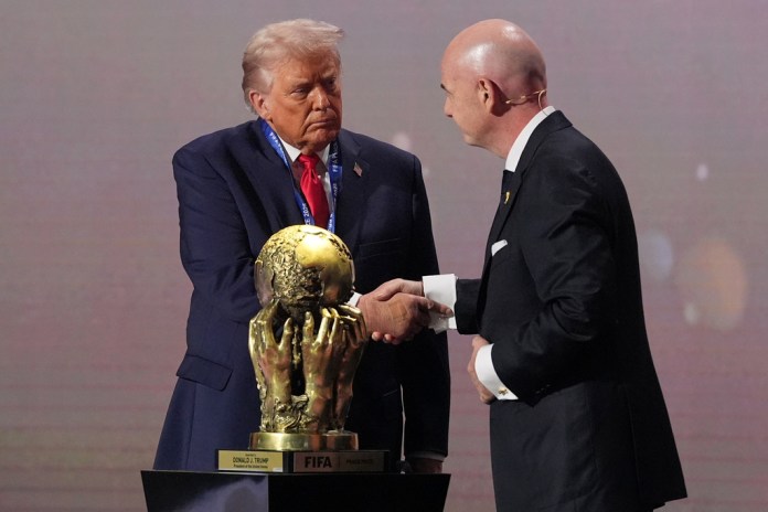 President Donald Trump receives the FIFA Peace Prize from FIFA President Gianni Infantino.