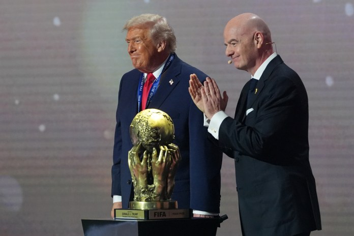 President Donald Trump receives the FIFA Peace Prize from FIFA President Gianni Infantino.