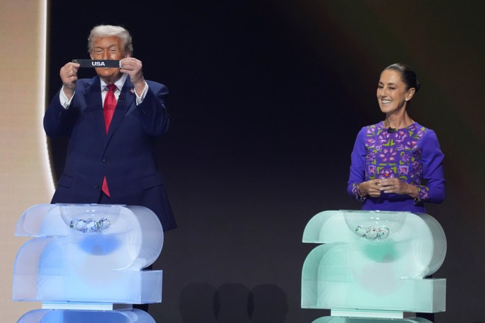 President Donald Trump smiles after drawing the U.S. from a pot as Mexican President Claudia Sheinbaum looks on.