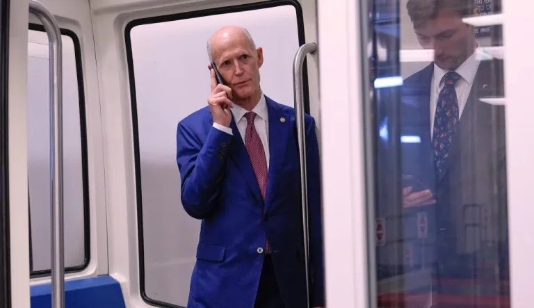 Sen. Rick Scott (R-FL) talks on the phone at the Capitol subway.