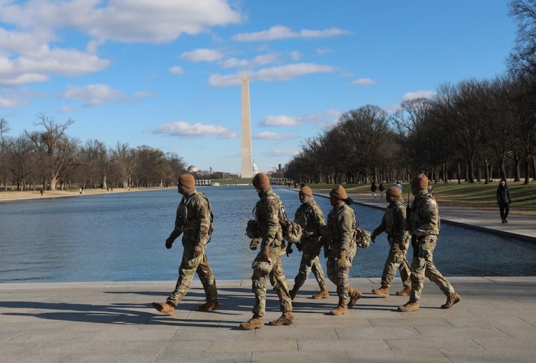 National Guard patrol in the Lincoln Memorial, Thursday, Dec. 11, 2025, in Washington. The Washington Monument is seen in the background. (AP Photo/Rahmat Gul)