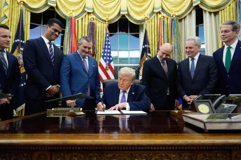 Trump signs AI executive order in the Oval Office.