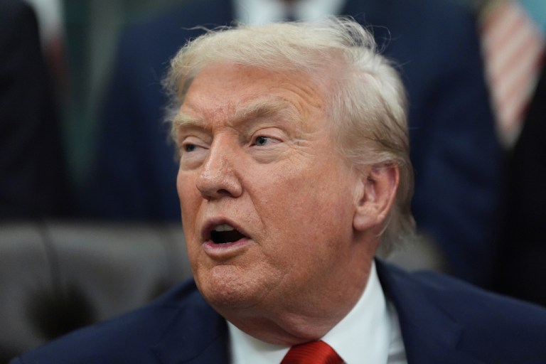 President Donald Trump answers media questions after a bill signing ceremony with members of the 1980 U.S. Men's Olympic Hockey team.