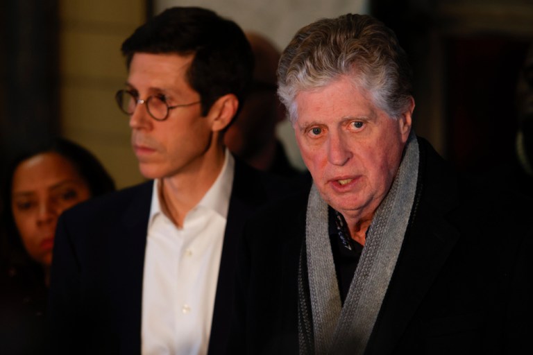 Rhode Island Gov. Dan McKee, right, speaks accompanied by Mayor Brett Smiley, left, during a news conference in Providence, R.I., following a shooting at Brown University on Saturday, Dec. 13, 2025.