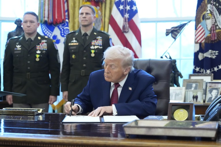 President Donald Trump signs a proclamation.