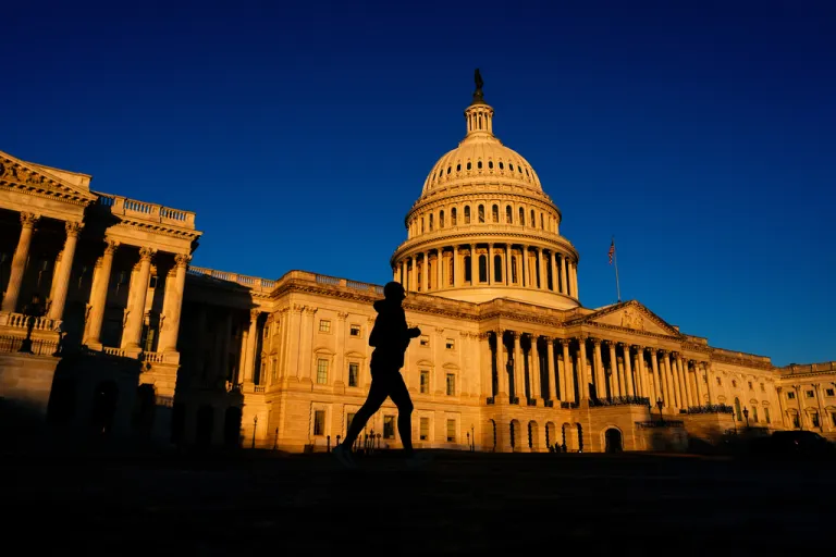 A runner jogs past the Capitol.
